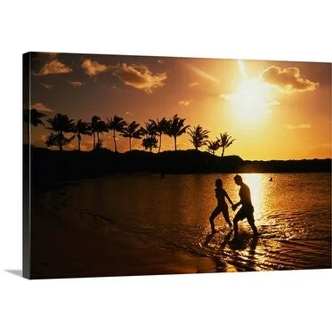 Linda Ching Premium Thick-Wrap Canvas entitled Couple walking out of the ocean silhouetted against a sunset and palm