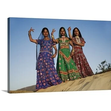 Premium Thick-Wrap Canvas entitled Three young Indian women in decorated saris performing a Rajasthani dance.